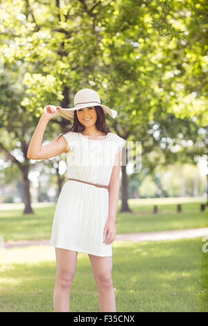 Portrait of confident happy woman holding sun hat Stock Photo
