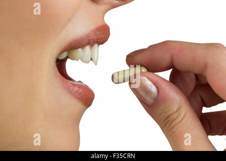 Close-up of woman taking tablet Stock Photo