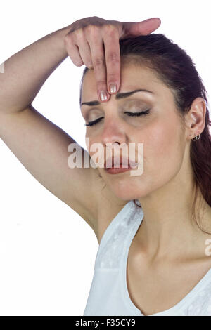 Woman with eyes closed white touching forehead Stock Photo