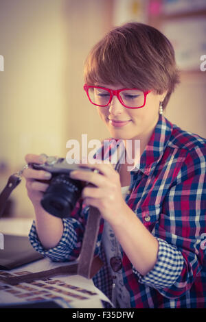 Smiling photographer looking at her camera Stock Photo