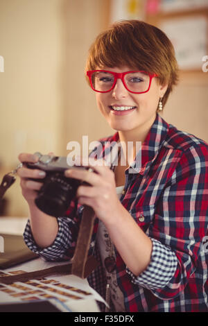 Smiling photographer looking at camera Stock Photo