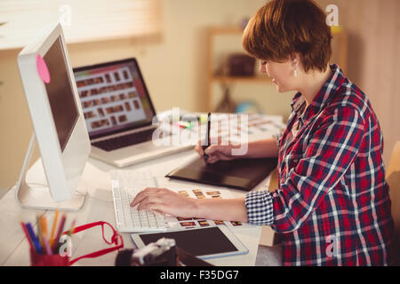 Focused photographer looking pics on her computer Stock Photo
