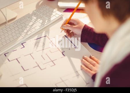 Creative businesswoman drawing plans on her desk Stock Photo