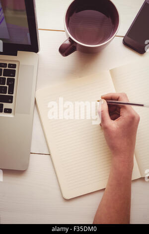 Businesswoman using her laptop at desk Stock Photo