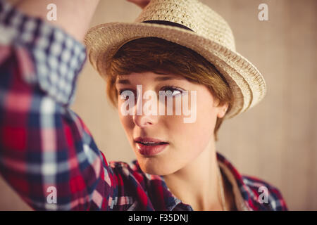 Attractive redhead woman holding her hat Stock Photo