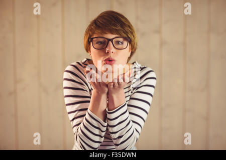 Pretty young woman blowing kisses Stock Photo