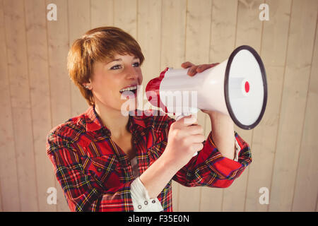 Pretty young woman using megaphone Stock Photo