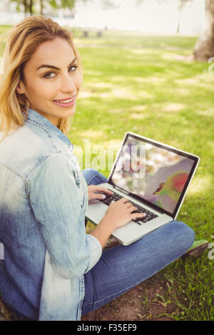 Portrait of smiling woman using laptop Stock Photo