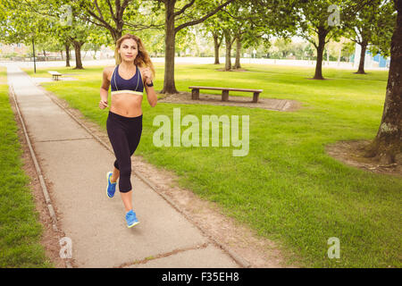 Woman jogging in park Stock Photo