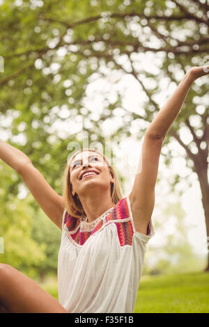 Smiling woman with hands raised Stock Photo