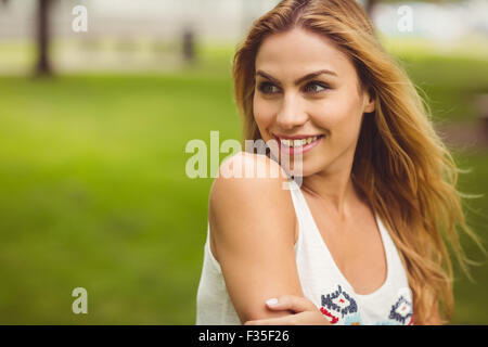 Cheerful woman looking away while standing on grass Stock Photo