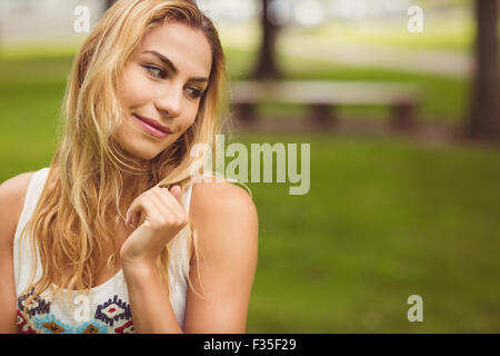 Beautiful smiling woman standing on grass Stock Photo