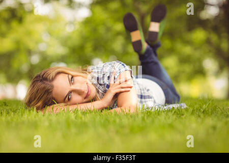 Woman lying on front at park Stock Photo