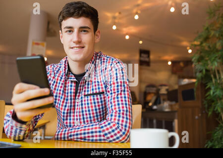 Portrait of happy young man using mobile phone Stock Photo