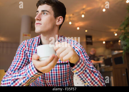 Young man holding coffee cup Stock Photo