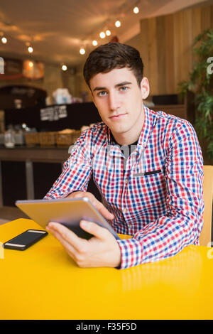 Portrait of young man using digital tablet Stock Photo