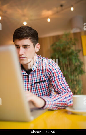 Confident young man using laptop Stock Photo