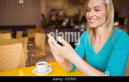 Happy young woman using mobile phone Stock Photo
