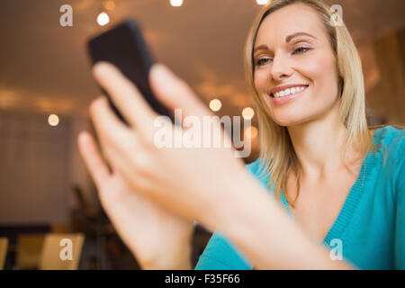 Happy young woman using mobile phone Stock Photo