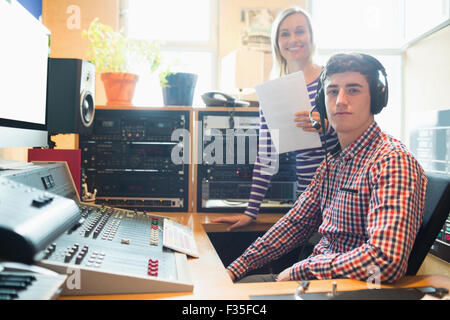 Portrait of male radio host with female employee Stock Photo