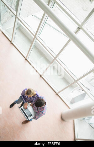 High angle view of college students using laptop Stock Photo