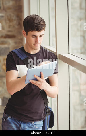 Male student using digital tablet in college Stock Photo