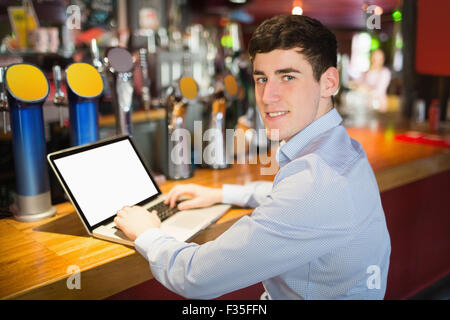 Portrait of happy man using laptop Stock Photo