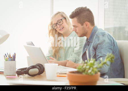 Smiling woman wearing eyeglasses talking with man Stock Photo