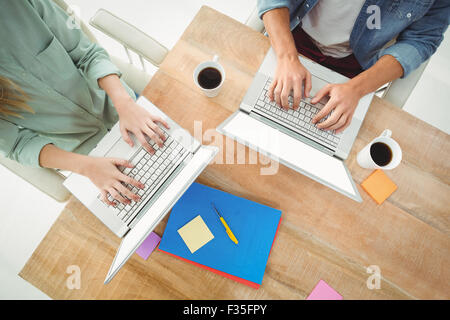 Midsection of man and woman using laptop Stock Photo