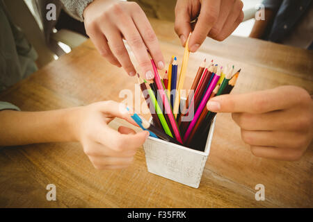 Close-up of cropped hands taking color pencils Stock Photo