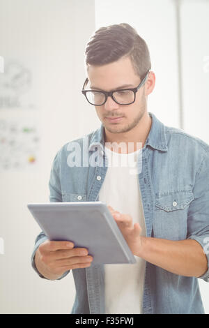 Serious man using digital tablet Stock Photo