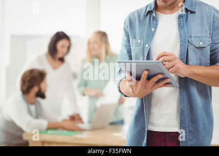 Mid section of man using digital tablet Stock Photo