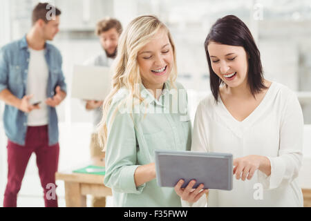 Smiling women using digital tablet Stock Photo