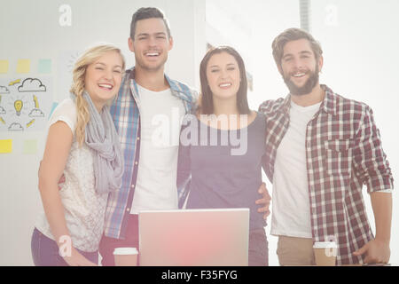 Portrait of smiling business people standing with arm around Stock Photo