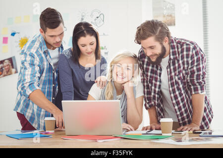 Colleagues working on laptop Stock Photo