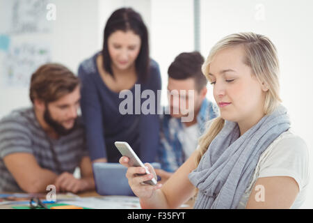 Smiling woman using smartphone Stock Photo