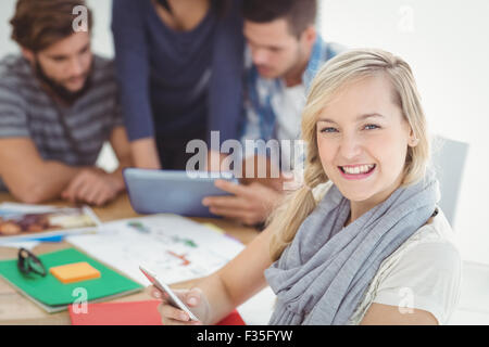 Portrait of cheerful woman using smartphone Stock Photo