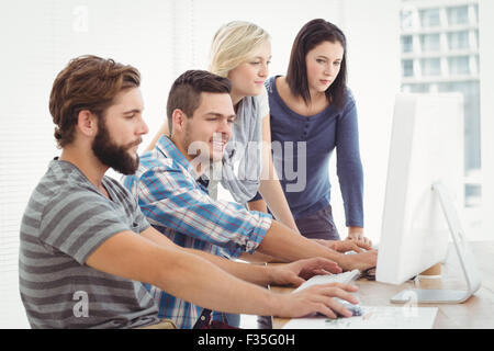 Business team working on computer Stock Photo
