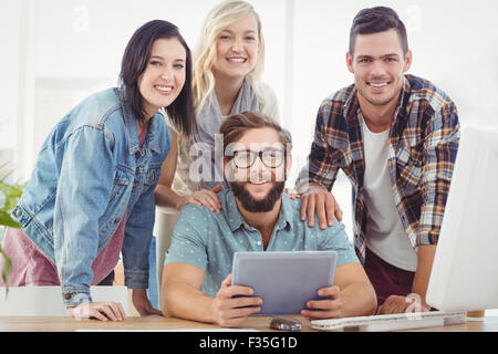 Portrait of smiling business people using digital tablet Stock Photo