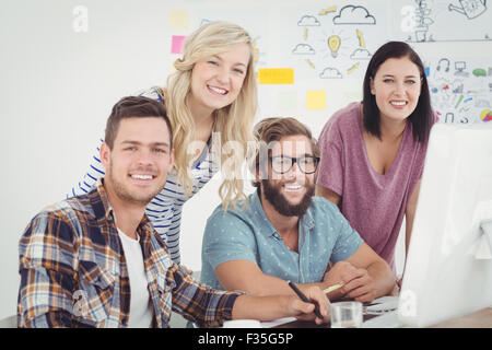 Portrait of cheerful  business professionals working at computer desk Stock Photo