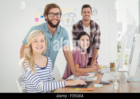 Portrait of smiling woman with coworkers Stock Photo