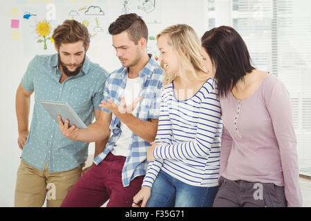 Man holding digital tablet gesturing Stock Photo
