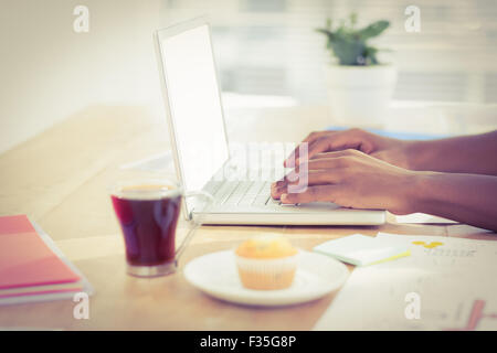 Cropped hands working on laptop at desk Stock Photo