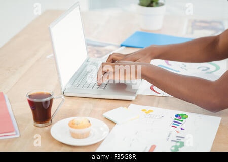 High angle view of cropped hands working on laptop Stock Photo