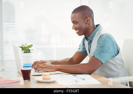 Smiling man working on laptop Stock Photo