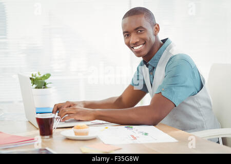 Portrait of smiling man working on laptop Stock Photo