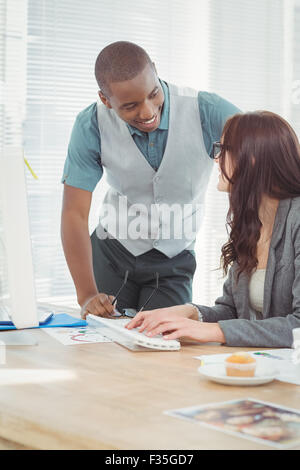 Smiling businessman discussing with coworker Stock Photo