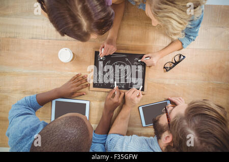 Overhead view of people writing business terms on slate Stock Photo