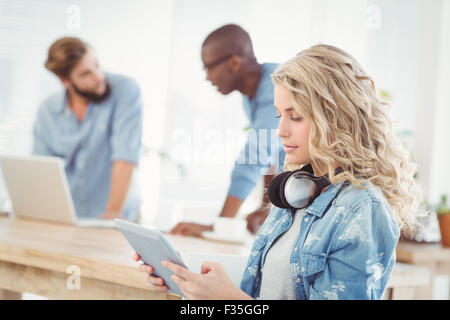 Side view of woman with headphones while using digital tablet Stock Photo