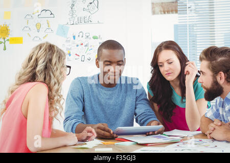 Business professionals using digital tablet in creative office Stock Photo